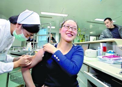 昨日，向雪敏在同濟醫(yī)院血液科病房打動員劑，丈夫陳武右在身后注視著妻子 記者傅克強