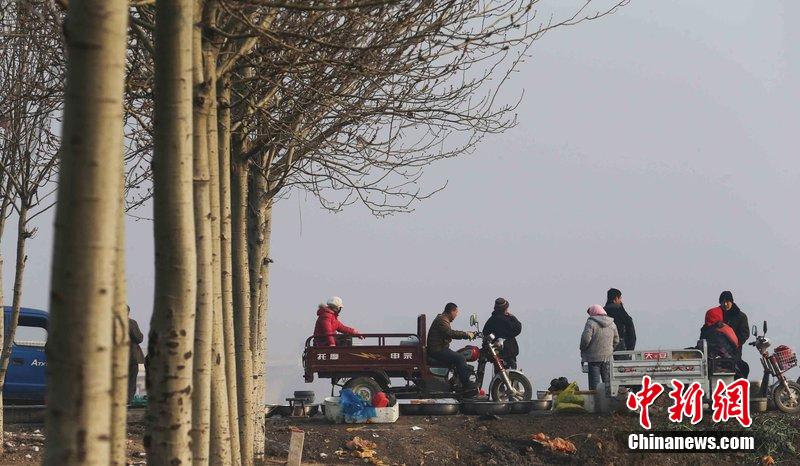 圖為12月1日，104國(guó)道靜海縣城附近，104國(guó)道靜?？h城附近，高速旁邊形成的黑市。田寶希 攝 圖片