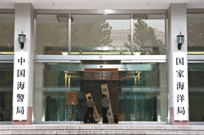 昨日，中國海警局掛牌成立。原國家海洋局和中國海監(jiān)總隊的牌匾被摘下，國家海洋局和中國海警局的新牌匾換上。黃冉 攝