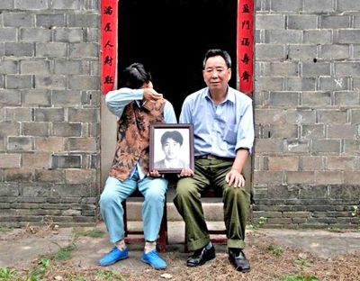 江蘇鎮(zhèn)江，老劉夫婦捧著獨生子的遺像在老家前留影南方都市報供圖L