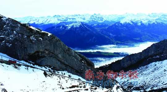  齒軌火車在皮拉圖斯山上穿行，如同紅色的龍?jiān)谏街杏芜? complete=