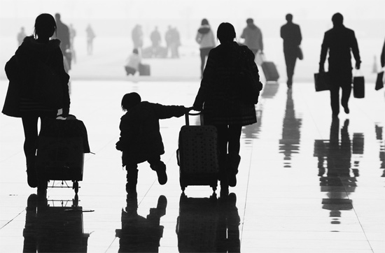 昨日，鄭州東站，一名孩子拉著媽媽和包裹快樂地奔走在春運的途中