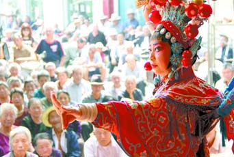 圖為8月15日戲曲演員在“流動(dòng)舞臺(tái)車”上表演傳統(tǒng)地方戲《穆桂英下山》。