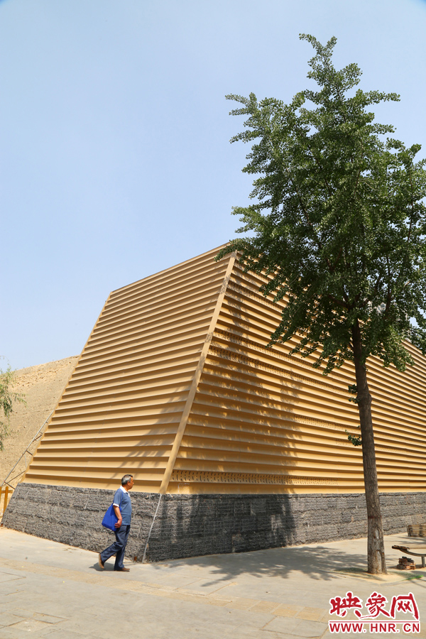 一名路人從“土豪金”保護(hù)殼前經(jīng)過。