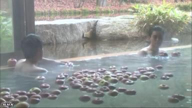 一個(gè)個(gè)蘋果漂浮在浴槽內(nèi)（NHK網(wǎng)頁截圖）。