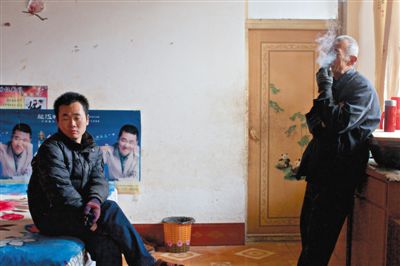 父親抽煙，兒子不語(yǔ)。逃跑的越南新娘，給袁迎賓父子帶來(lái)的是失落。新京報(bào)記者 周崗峰 攝