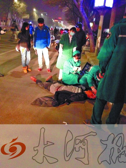 醉漢躺在地上，醫(yī)護(hù)人員對其進(jìn)行檢查。